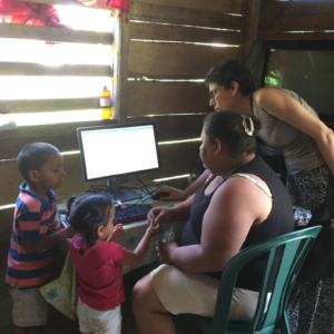 Two woman and two children using a computer